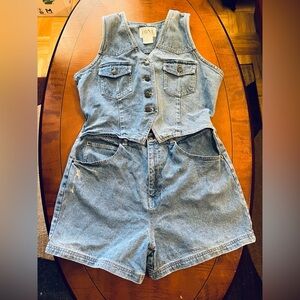 Short denim romper. Attached sleeveless top, open-belly. Slightly distressed. L